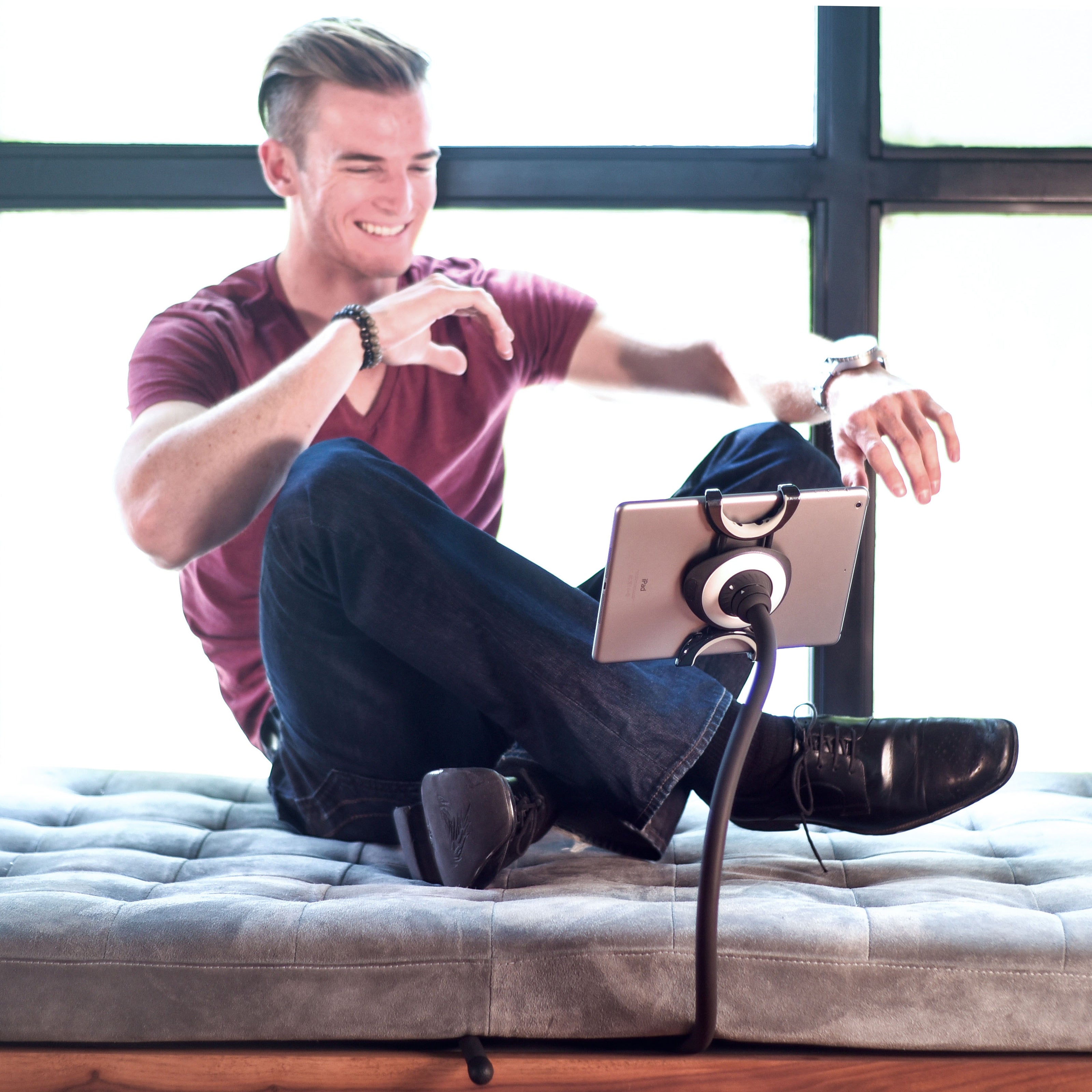 Spider Monkey flexible tablet stand beside a couch