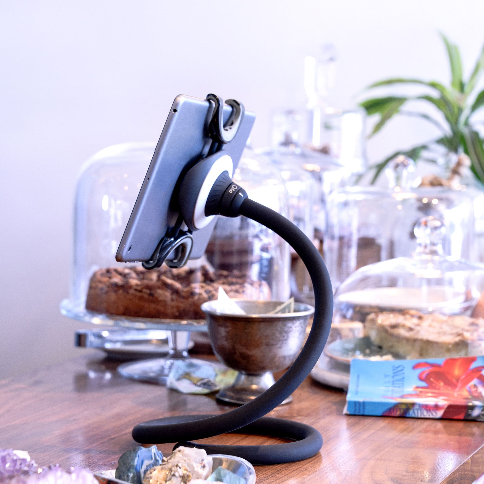 Spider Monkey tablet stand in use at a coffee shop table